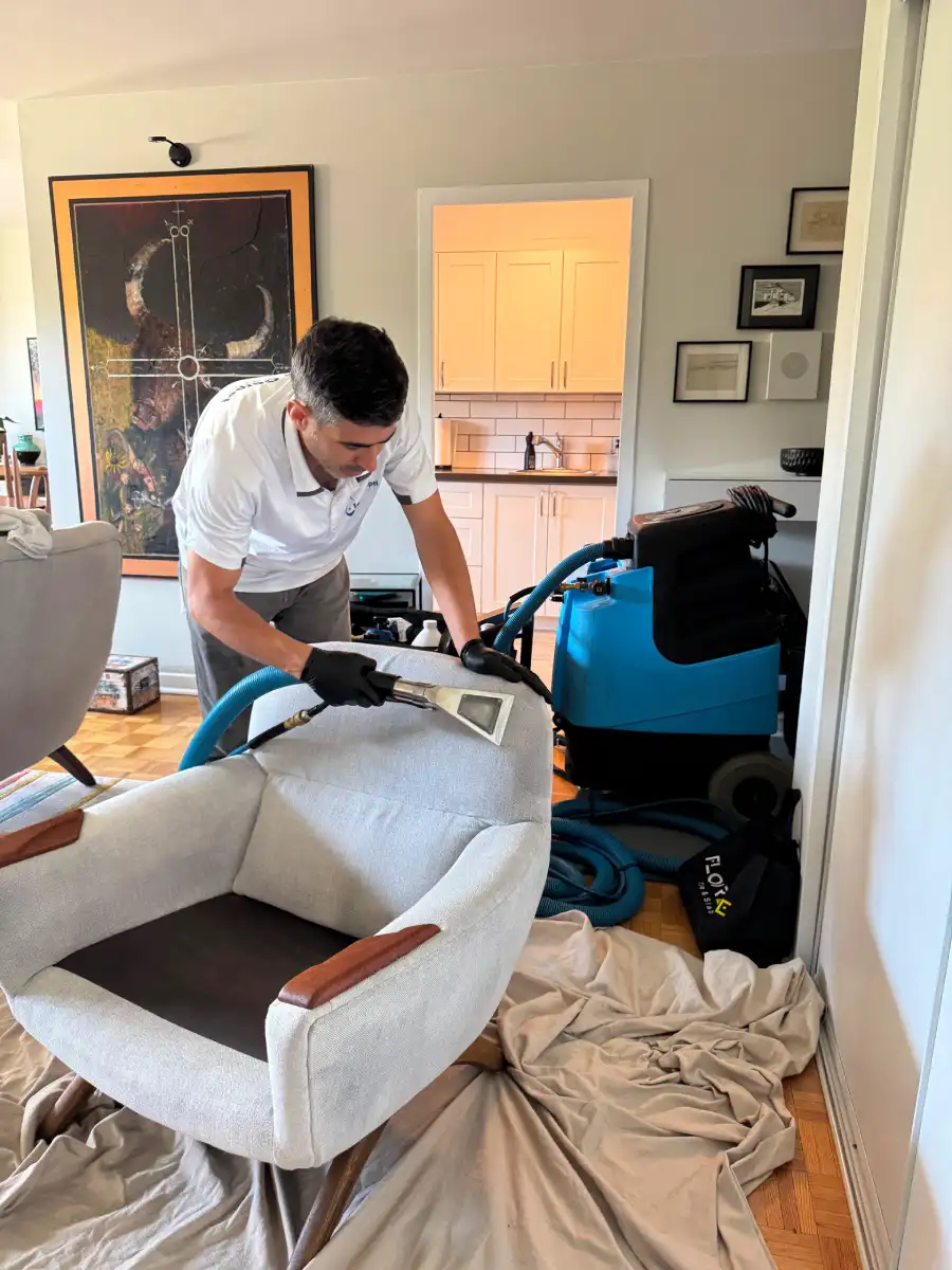 Upholstery cleaning in North York - technician deep steam cleaning a fabric sofa